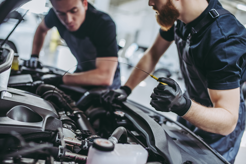 Two technicians working on a vehicle