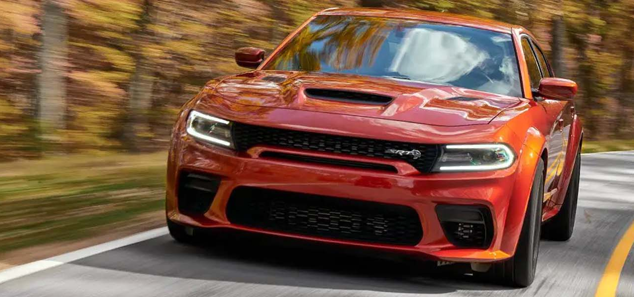 A 2023 Dodge Charger driving through the woods