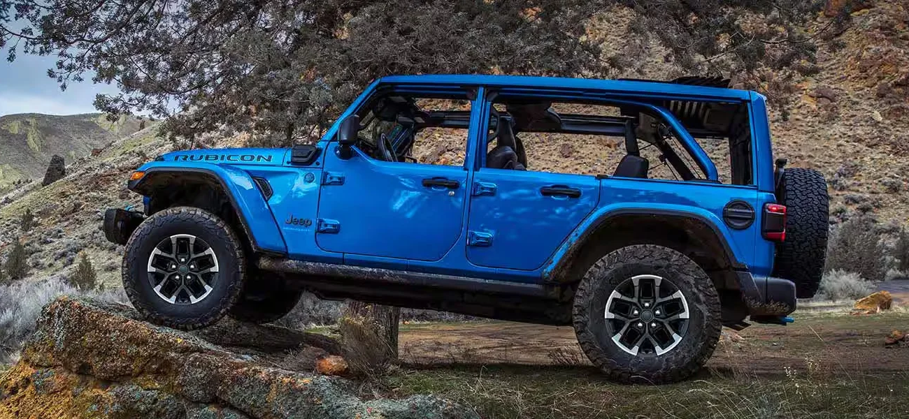A 2025 Jeep Wrangler traversing a mountain range