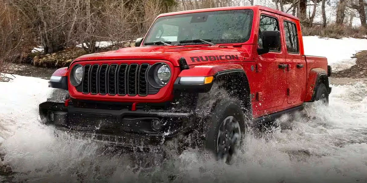A 2024 Jeep Gladiator driving through snow