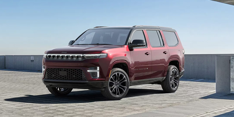 The image showcases a maroon Jeep Wagoneer, emphasizing its premium and rugged SUV design, set against a modern architectural background that complements its strong presence.
